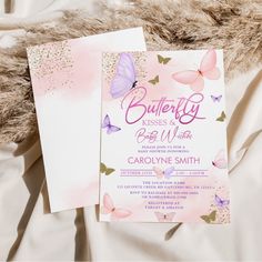 two pink and purple butterflies are on the cover of a white sheet that is laying on top of a fur