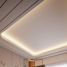 a bedroom with white walls and lights on the ceiling is lit by recessed lighting