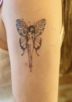 a woman with a butterfly tattoo on her arm