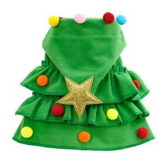 a dog wearing a green christmas tree dress with pom poms on it's head