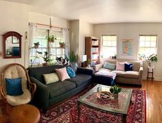 a living room filled with furniture and lots of windows