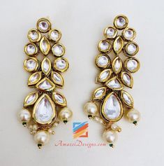 Ravishing Heavy High Quality White Kundan Set Necklace Earring Tikka Set. - High Quality Original Kundan Set - Necklace with Hanging Beads - Small Earrings - Small Elegant Tikka Shop for more KUNDAN SETS. Why Amazel Designs? Customer Testimonial - Aisha, Canada My experience with Amazel designs was amazing! She was super nice and the product was just as expected. It was beautiful and the quality was great! Thank you for the excellent and fast service! :) I will definitely be ordering more stuff! Jeweled Drop Earrings For Celebrations, Elegant Beaded Bridal Earrings For Festivals, Elegant Festive Beaded Chandelier Earrings, Elegant Chandbali Beaded Earrings, Elegant Beaded Chandbali Earrings, White Hand Set Chandelier Earrings For Celebrations, White Kundan Necklace With Matching Earrings In Temple Style, Gold Pearl Earrings With Hand Set, Festive Dangling Beads Drop Earrings