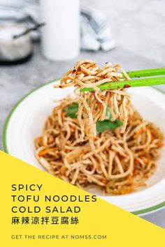 a white plate topped with noodles and chopsticks