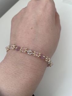 a person's arm with a bracelet on it