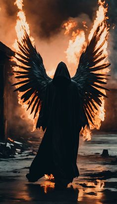 an angel with wings standing in front of fire