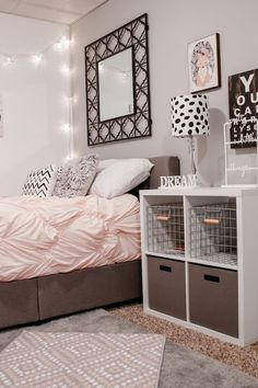 a bedroom with white walls and pink bedding