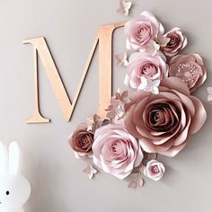 a wall clock with paper flowers on it and a bunny figurine next to it