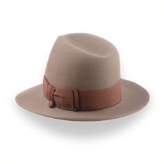 Description Materials Craftsmanship Hat Care Shipping Returns Product Description h2 { font-weight: lighter; } h3 { font-weight: lighter; padding-top:15px; } strong { font-weight: lighter; } Boost Your Look with a Light Brown Indy Fedora Experience the perfect blend of cinematic and contemporary style with the Pharaoh, a light brown Indy fedora. Crafted from luxurious beaver fur felt, this hat offers a smooth, premium finish. The 5 1/2" crown and 2 3/4" raw-edge snap brim create a stylish silhou Homburg Hat, Outdoor Hut, Gambler Hat, Strong Font, The Raid, Mens Hats Fashion, Fedora Hat Men, Homburg, Trilby Hat