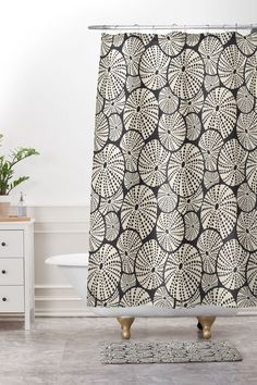 a black and white shower curtain with an intricate design on the front in a bathroom