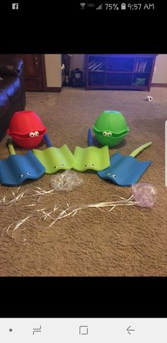 two paper hats are laying on the floor next to some plastic construction cones and wires