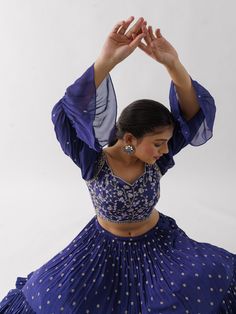 A three-piece Purple lehenga set from the Suruchi Parakh collection. This elegant georgette crepe lehenga is paired with a hand-embroidered blouse. The outfit is completed with a matching georgette crepe dupatta. The bell sleeve blouse has a cutwork neckline. And, the purple dupatta has a beautiful touch of ruffle with an embellished border. Georgette Choli With Mirror Work, Floor-length Georgette Palazzo Set For Transitional Seasons, Transitional Floor-length Georgette Palazzo Set, Georgette Palazzo Set With Cutdana For Reception, Traditional Drape Palazzo Set With Unstitched Blouse, Chinon Sets For Reception At Navratri, Traditional Drape Georgette Sharara For Transitional Season, Semi-stitched Palazzo Set For Reception And Navratri, Georgette Palazzo Set With Cutdana For Navratri