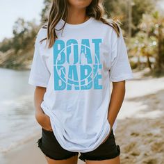 Hey there, Boat Babe! Are you ready to sail through life in style? Introducing our "Boat Babe" Comfort Color Tee – the perfect blend of nautical charm and laid-back comfort! Crafted from premium Comfort Color fabric, this tee feels as soft as a sea breeze against your skin. The playful "Boat Babe" graphic celebrates your love for all things maritime, whether you're out on the water or lounging on the shore. Whether you're setting sail on a yacht or simply daydreaming about your next seaside adve Nautical Beach Tops For Summer, Nautical Tops For Beach In Summer, Nautical Style Beach Tops For Summer, White Nautical Tops For Vacation, Nautical Blue Top For Beach, Nautical Short Sleeve Beach Top, Nautical Cotton Tops For The Beach, Summer Boating T-shirt With Short Sleeves, Summer Short Sleeve T-shirt For Boating