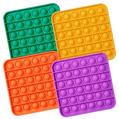 three different colored trays with circles on the bottom and one has an egg in it