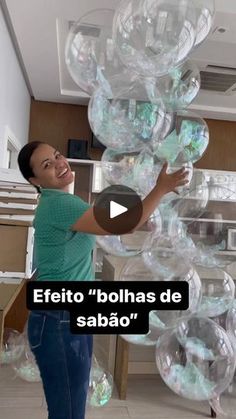 a woman standing in front of a bunch of clear balls on top of a counter