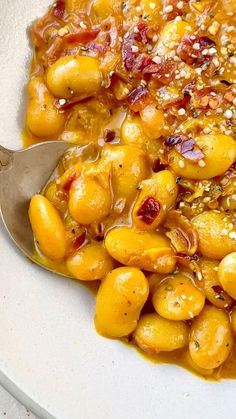 a white bowl filled with food and a spoon