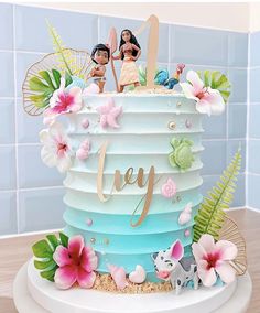 there is a cake decorated with barbies and flowers on the top it says joy