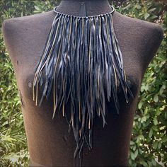 "-This dramatic necklace is made from soft black leather. Vintage brass chains peek out of the leather fringe. -The collar is adjustable from 15\" - 17\" with a 2\" adjuster chain in the back. Longer adjuster chain available by request. -Leather fringe drapes 10\" from the collar at the longest point. -A versatile statement piece, this fringe necklace is equally stunning as festival wear, evening wear, or with lingerie. -Shown on model with our Leather Biker Cuff & Heavy Metal Cuff. -Designe Black Fringe Jewelry For Festival, Elegant Leather Fringe Jewelry, Adjustable Leather Party Necklaces, Adjustable Leather Party Necklace, Elegant Leather Necklace For Festivals, Bohemian Black Leather Necklace, Oversized Necklace, Dramatic Necklace, Gothic Bride