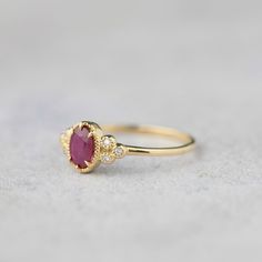 Unique art deco inspired ruby & diamond ring comes in a 100% recycled 14k solid gold. Accentuated with three beautiful diamonds clustered on both sides complementing the romantic beauty of ruby. Purchase this as an everyday ring or engagement ring for your special someone. This elegant ring will make every woman look and feel uniquely beautiful. Ruby is a birthstone of July so it will make the perfect gift for July babies. The color red represents LOVE and will make the perfect birthday gift 14k Gold Red Cluster Ring With Rose Cut Diamonds, 14k Gold Ruby Ring With Rose Cut Diamonds, Lab-created Ruby Ring With Rose Cut Diamonds For Promise, Heirloom 14k Gold Ruby Ring With Single Cut Diamonds, Red Ruby Ring With Diamond Accents In 14k Gold, Ruby Diamond Engagement Ring, Birthstone Engagement Rings, Alternative Engagement Ring, Emerald Earrings Studs