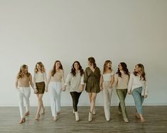 a group of women standing next to each other on top of a hard wood floor