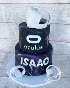 a three tiered cake with the word oculus on it and an earbud