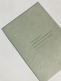 a close up of a business card on a white surface with the words saks