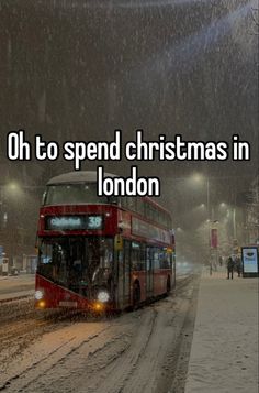 a red double decker bus driving down a snow covered street with the words oh to spend christmas in london