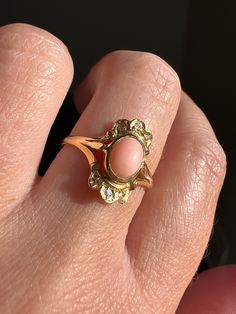 Selling a collection of vintage to antique rings. Many more coming soon - thanks for stopping by!  : ) ABOUT: Unique form to this beautifully colored angel skin coral ring.  The smooth oval pale pink coral is accented by single cut diamonds above and below with scalloped gold work giving it an ornate appearance like a tiara ring.  Low profile, so pretty!  I'm not sure when this was made.  It is at least vintage, possibly older but it doesn't look like the fabrication is as old as many of my Vict Pink 14k Stamped Fine Jewelry Rings, Pink 14k Stamped Promise Ring, Antique Pink Jewelry For Formal Occasions, Vintage 14k Stamped Promise Ring Jewelry, Vintage Cabochon Ring, Vintage 14k Stamped Promise Ring, Antique Cabochon Rings For Anniversary, Vintage 14k Stamped Ring, Vintage Pink Rings For Anniversary