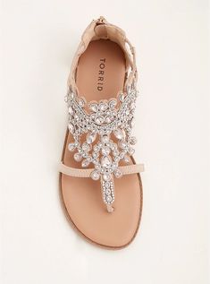 a pair of sandals with jewels on them