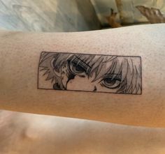 a woman's arm with an anime character tattoo on it