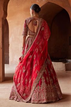 Cardinal red attached cancan lehenga with gold dabka, zari, sequin, bead, crystal embroidery in floral pattern. Paired with embroidered padded blouse and dupatta.
Components: 3
Pattern: Embroidery
Type Of Work: Dabka, zari, sequin, bead, crystal
Neckline: Notched
Sleeve Type: Three quarter
Fabric: Raw Silk, Net
Color: Red
Other Details: 
Lehenga:
Attached cancan
Floral pattern
Length: 45 inches
Blouse:
Padded
Bead drops on hem
Back cut-out
Tassel detailing at the back
Dupatta:
Embroidered scallo Red Sets With Tilla In Traditional Drape, Red Sets With Tilla Detail And Traditional Drape, Red Cutdana Lehenga For Reception, Red Festive Tilla Sharara, Red Tilla Choli For Navratri, Red Bollywood Choli With Tilla Detail, Bollywood Style Red Choli With Tilla Details, Festive Red Sets With Tilla Details, Festive Red Tilla Sets