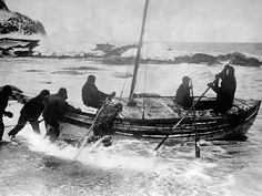 an old black and white photo of people in a boat