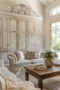 a living room filled with furniture and lots of white paint on the walls in front of a large window