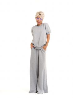 Take your athleisure looks to the next level. Our sweatsuit set combines the comfort of casual dressing with eye-catching streetwear elements for an elevated everyday look. FEATURES:A grey sweatsuit set with a pleated tulle panel at the back. The top has short puff-sleeves. The bottoms have an elastic waistband and functional side pockets.100% Handmade. SIZE & FIT: Fit: A relaxed fit with room to moveModel is wearing size Small or S/M View our SIZE CHART before ordering MATERIALS & CARE: Content: Viscose Care: Machine wash on cold (30ºC) with a mild detergent. SHIPPING: Made to order, processing time is 15 working days This item will be shipped via DHL Grey Sweatsuit, Athleisure Looks, Pleated Tulle, Casual Dressing, Sweatsuit Set, Brand Magazine, Stocking Fillers For Her, Locker Room, Co Ord Set