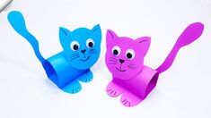 two paper cats sitting next to each other