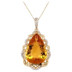 Stunning citrine diamond pendant. High brilliance, golden honey tone, transparent clean, pear shape faceted, natural 21.84 carats citrine mounted on high profile open basket with 4 bead prongs and knife prong, accented with round brilliant cut diamonds. Handcrafted design set in 14 karats yellow gold with 10 karats, 16 inches long box chain with spring clasp. Citrine: 21.84 carats, high brilliance, golden honey tone, pear shape Diamond: 0.40 carat, round brilliant cut Color: G-H Clarity: SI1 - S Ruby Diamond Pendant, Ruby Diamond Necklace, Pink Diamond Earrings, Sapphire Diamond Necklace, 1st Dibs, Cocktail Earrings, Golden Honey, Fancy Yellow Diamond, Diamond Bangles Bracelet