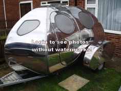 a silver trailer parked in front of a brick building