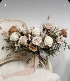 a bouquet of flowers sitting on top of a white chair