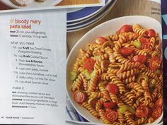 a recipe book with an image of pasta and tomatoes in it on a table top