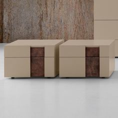 three tan boxes sitting next to each other in front of a stone wall and floor