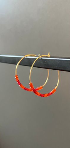 This pair of hoop earrings is handmade from glass seed beads, and is beaded onto gold colored wire. This design is inspired by strawberry mango candy. The diameter of the hoop is ~1.25 inches. Size may vary slightly due to bead patterns and/or width. Mango Candy, Glass Seed Beads, Bead Patterns, Jewelry Earrings Hoops, Jewellery Making, Salt Lake City, Lake City, Beading Patterns, Seed Beads