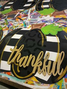 a painted sign that says, thank you all and has gold lettering on the front