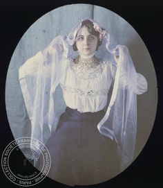 an old photo of a woman with veils on her head