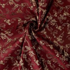 a red and gold fabric with floral designs