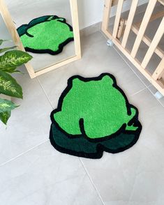 two green rugs on the floor in front of a mirror and potted plant