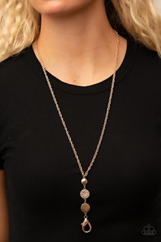 A white rhinestone encrusted gold frame is flanked between two gold discs scratched in a glistening shimmer as they drip from an ornately double-linked gold chain down the chest. A lobster clasp hangs from the bottom of the design to allow a name badge or other item to be attached. Features an adjustable clasp closure.

Sold as one individual lanyard. Includes one pair of matching earrings. Lanyard Necklace, Gold Disc, Paparazzi Accessories, White Rhinestone, Necklace Online, Affordable Jewelry, Paparazzi Jewelry, Earrings Gold, Gold Frame