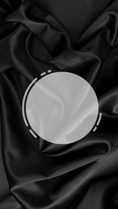 a white circle on black satin