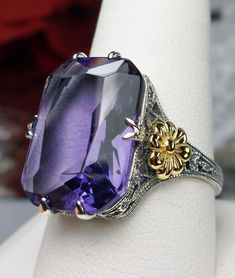 Simulated Amethyst Ring  Gold Daisy Design#208 Custom Made This is a lovely Edwardian/Art Deco era reproductions ring. I now offer this lovely filigree reproduction in sterling silver. This is a flawless Man-made/Simulated purple amethyst is 18mm by 13mm in size. The ring is 3/4th of an inch (19mm) NS on the finger. The inside of the band is etched 925. Notice the intricate and detailed floral design of the antique patina silver filigree setting all the way down the band, and the gold plated flo Amethyst Art, Beach Inspiration, Purple Ring, Gold Amethyst Ring, Floral Filigree, Art Deco Floral, Edwardian Art, Purple Rings, Handmade Sterling Silver Rings