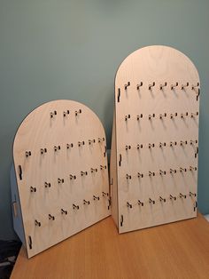 two wooden boards with numbers on them sitting on a table next to a wall mounted clock