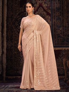 Introducing our captivating peach georgette saree with sequin, thread, and zari work, a perfect blend of tradition and contemporary style. This saree, in a vibrant peach hue, is designed to make a striking statement at weddings, festivals, parties, and other special occasions. The peach color is both fresh and sophisticated, adding a touch of elegance to your wardrobe and enhancing your presence at any event.
Crafted from high-quality georgette fabric, this saree offers a lightweight and gracefu Elegant Peach Traditional Wear For Festive Occasions, Elegant Peach Traditional Festive Wear, Peach Sharara With Sheer Dupatta In Georgette, Peach Georgette Sharara With Sheer Dupatta, Traditional Pre-draped Peach Saree With Zari Work, Bollywood Style Peach Traditional Wear With Cutdana, Elegant Semi-stitched Traditional Wear In Peach, Elegant Peach Georgette Traditional Wear, Peach Traditional Wear For Diwali Reception