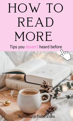 a cup of coffee sitting on top of a wooden table next to an open book